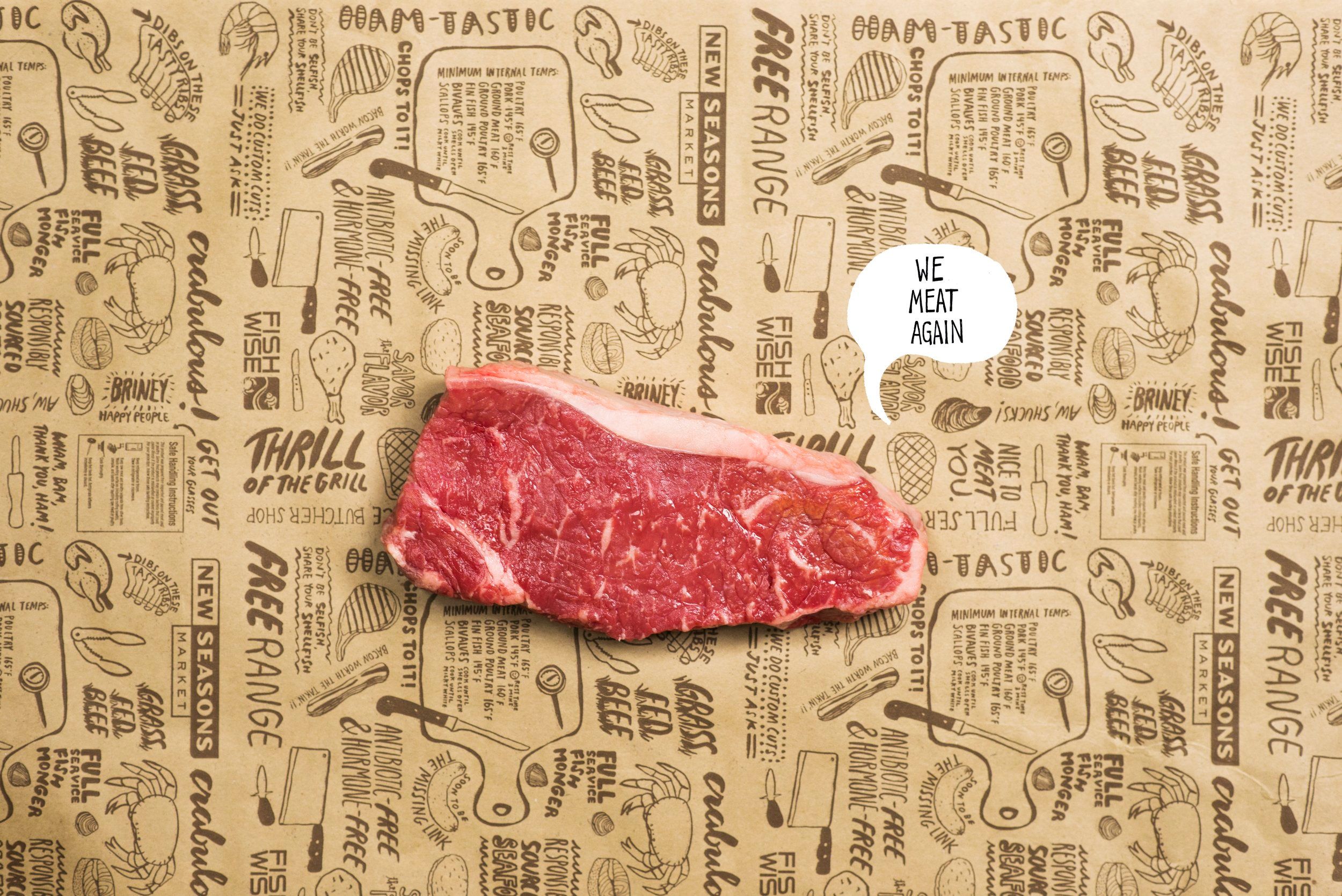 A cut of steak sitting on brown paper with several phrases and illustrations printed on it, with the text “We meat again” placed next to the steak in a speech bubble