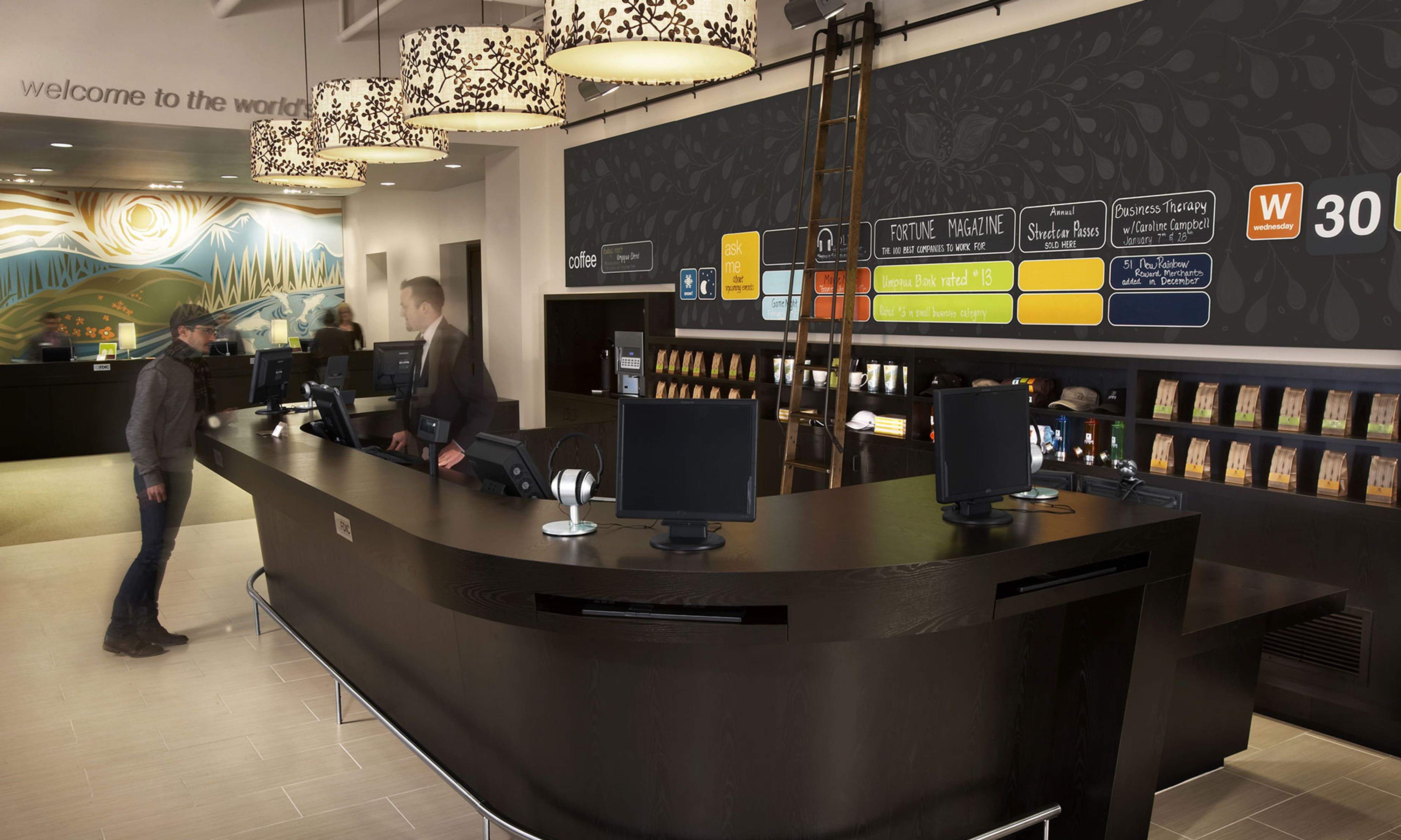 Person in a suit standing behind a service desk helping a customer