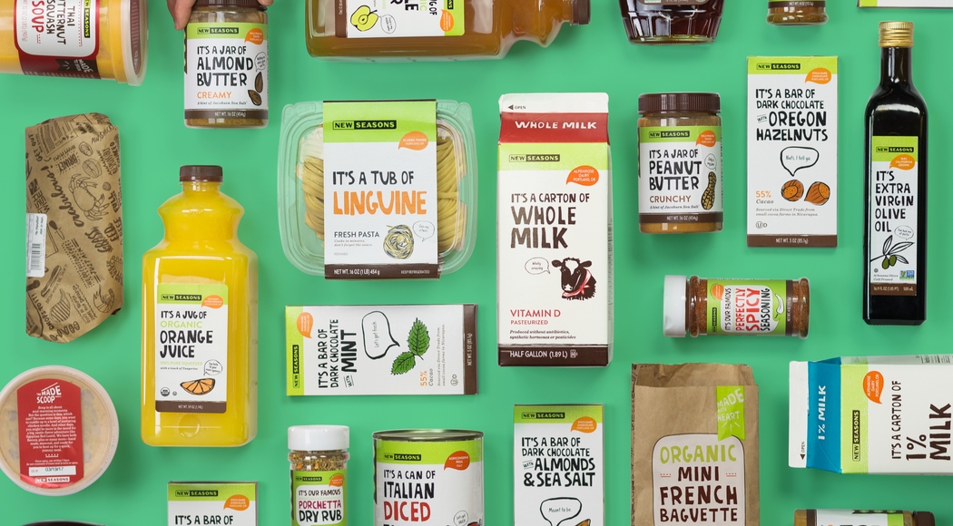 Several New Seasons products, including milk, orange juice, chocolate, spices, bread, and more placed neatly next to each other horizontally and vertically on a green background