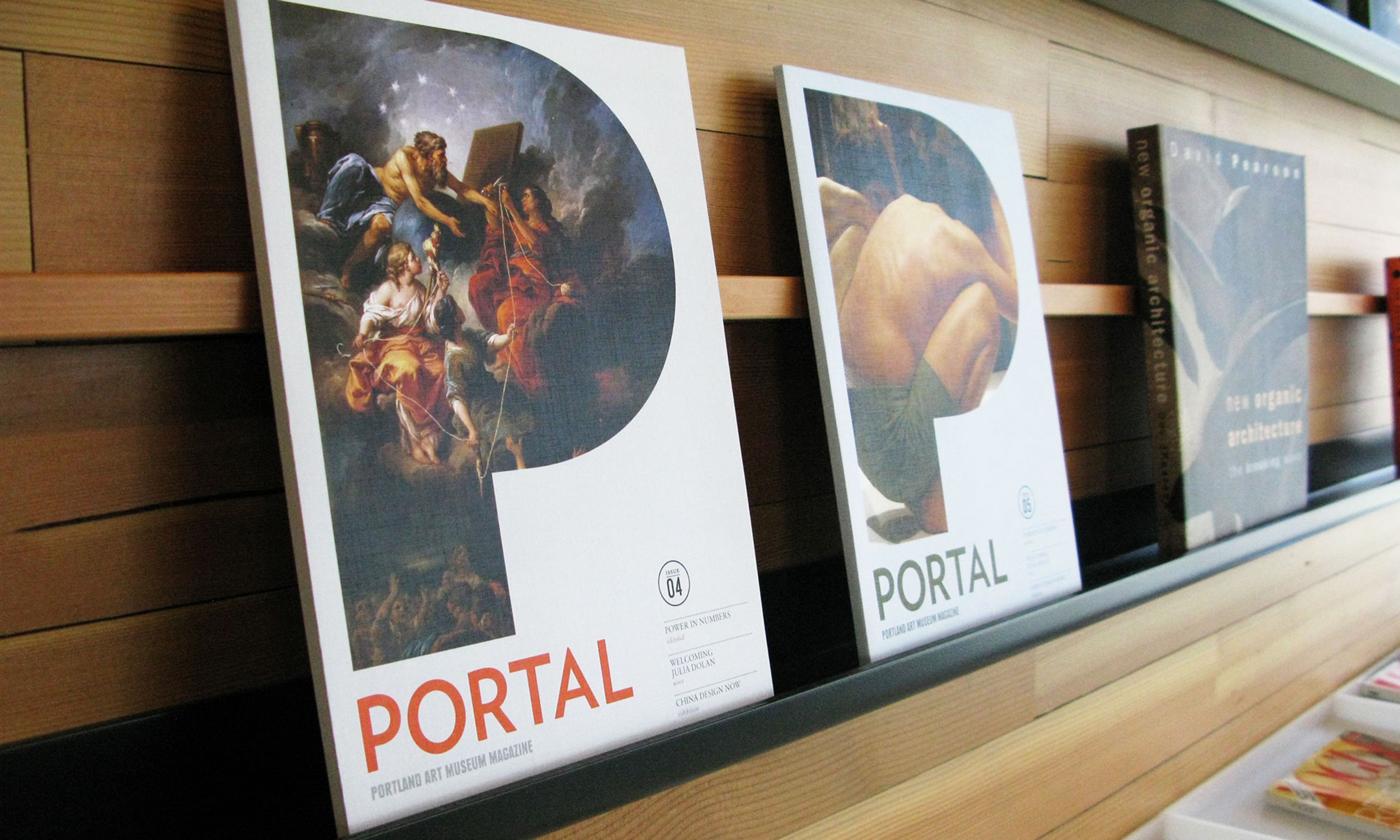 Two copies of the Portland Art Museum Magazine that feature large stylized P shapes that contain classical works of art