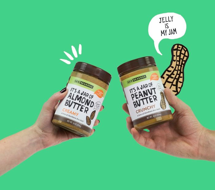Two people holding jars of almond butter and peanut butter in front of a green background, with an illustrated peanut in the background with a speech bubble coming from it reading “Jelly is my jam”