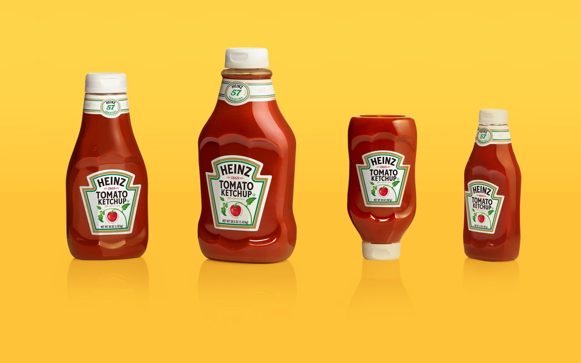 Four examples of a redesigned Heinz ketchup bottle in different sizes and form factors, placed on a yellow background