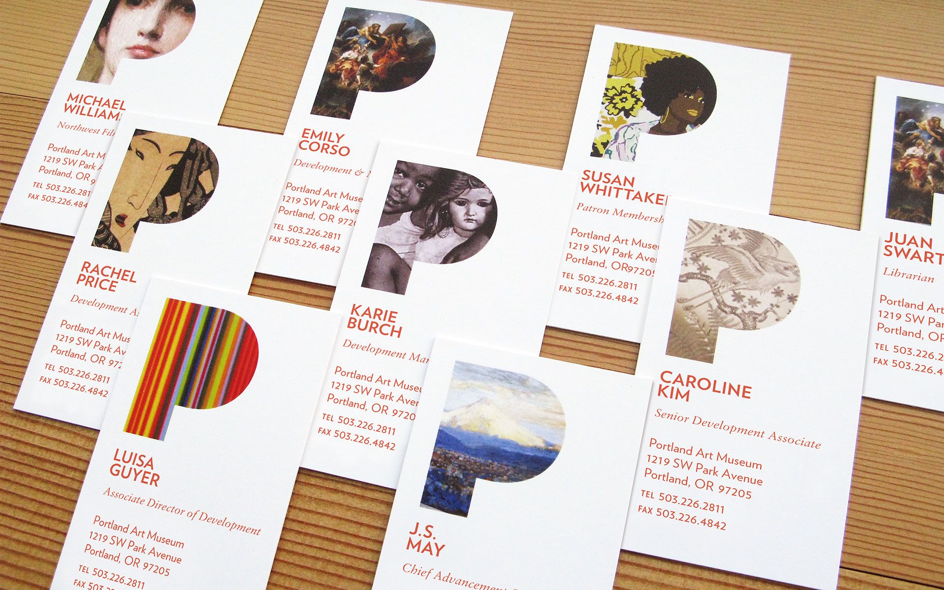 Several business cards for Portland Art Museum employees that feature art placed within a stylized P cutout