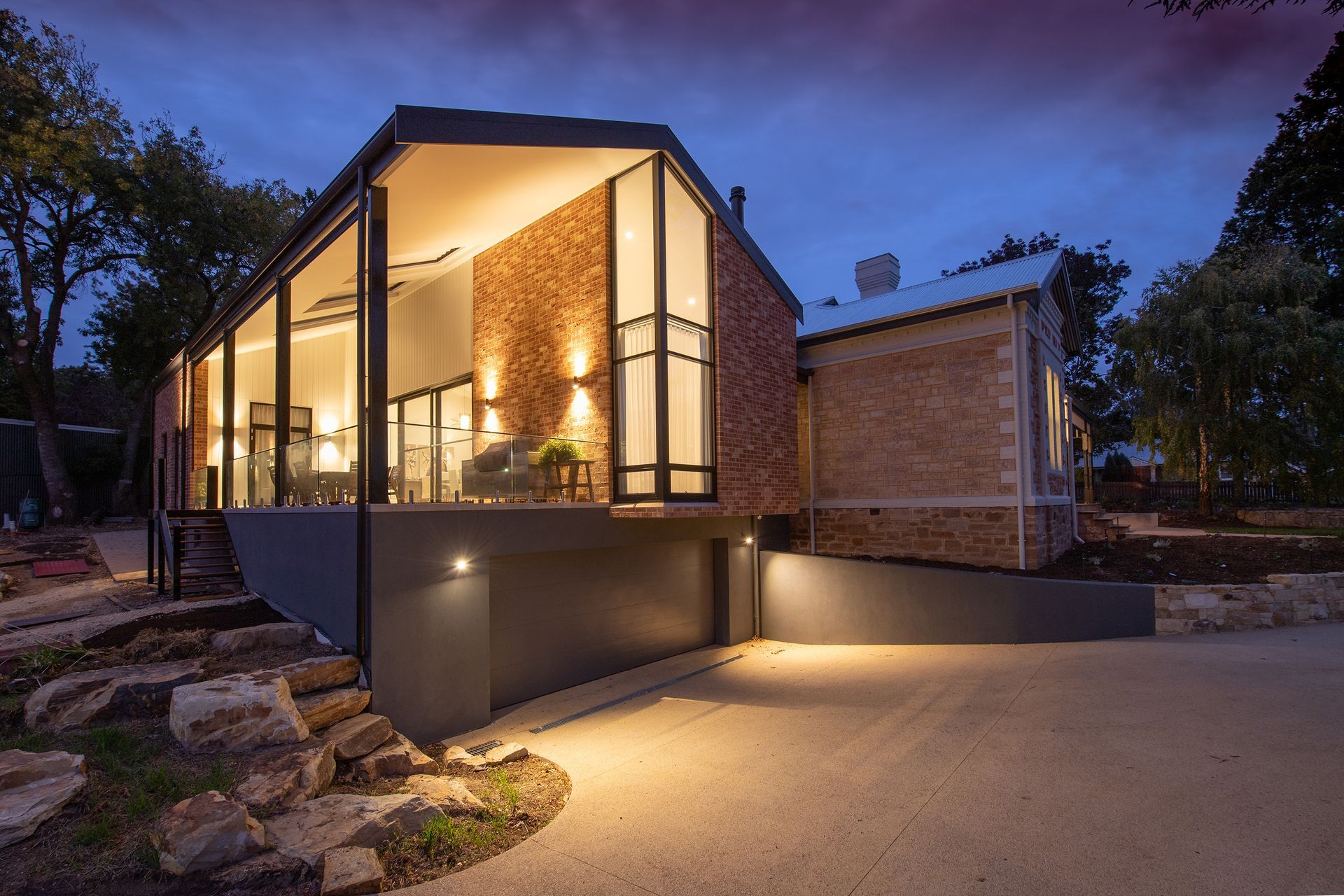 Modern home exterior lit at dusk