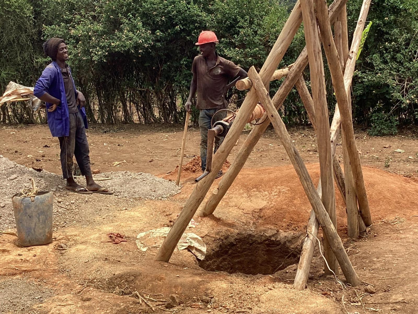 Workers preparing a site for a community water project.