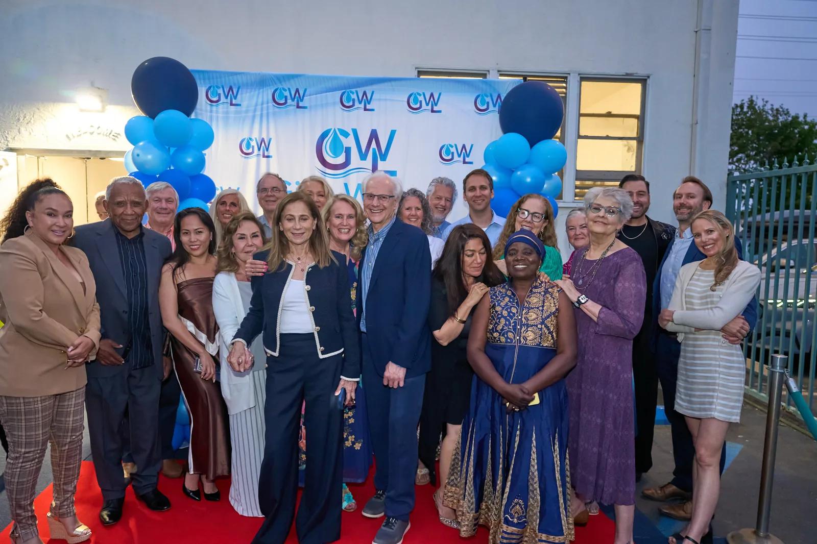 Guests gathered in front of the Give Water Give Life backdrop at the 2026 Gala.