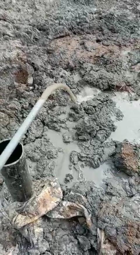 Water being discharged beside the borehole.