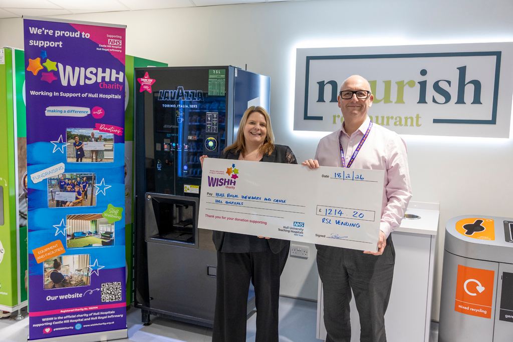RSL team member presenting cheque to WISHH Charity