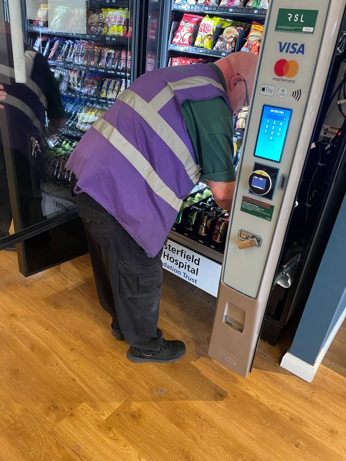 Filling up vending machine with snacks, and cold drinks