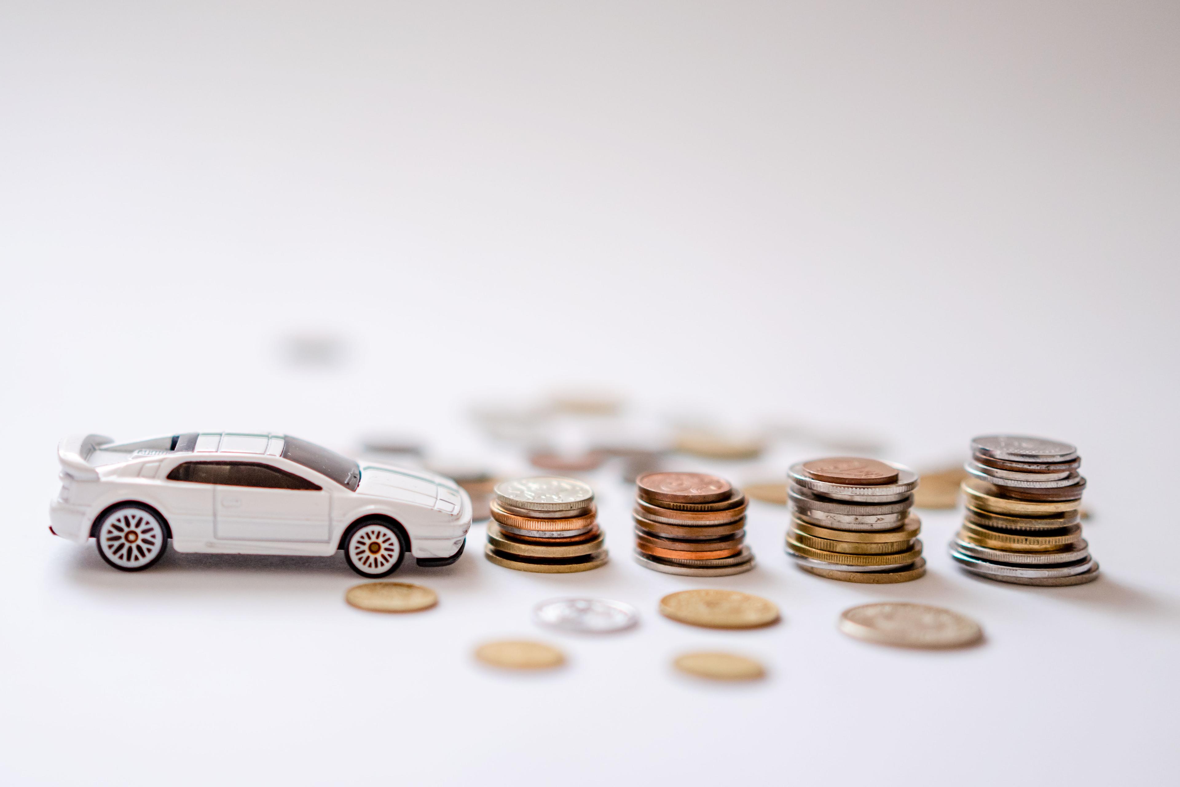 Miniature car with some coins.