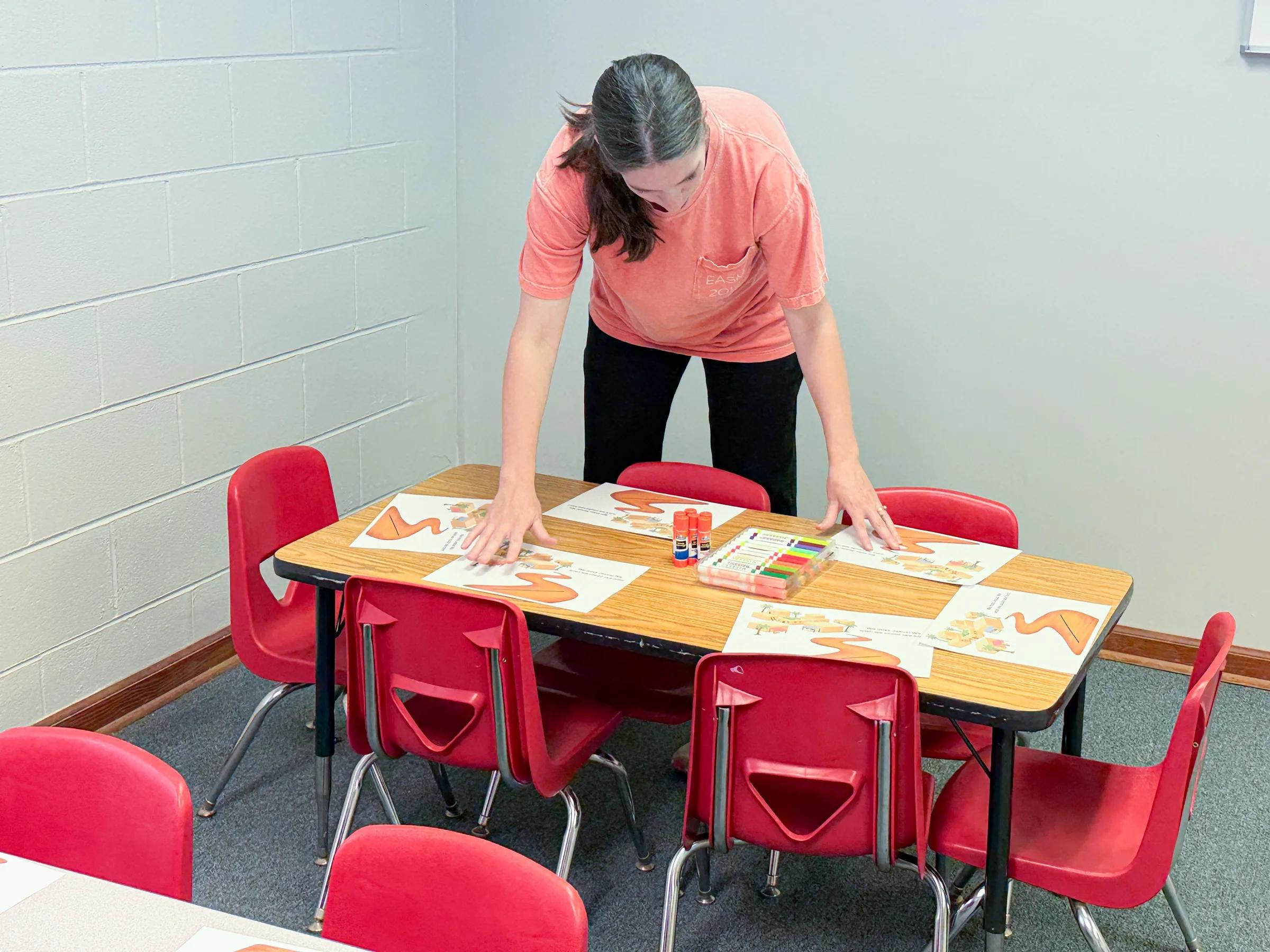 A volunteer prepares a creative activity for children.