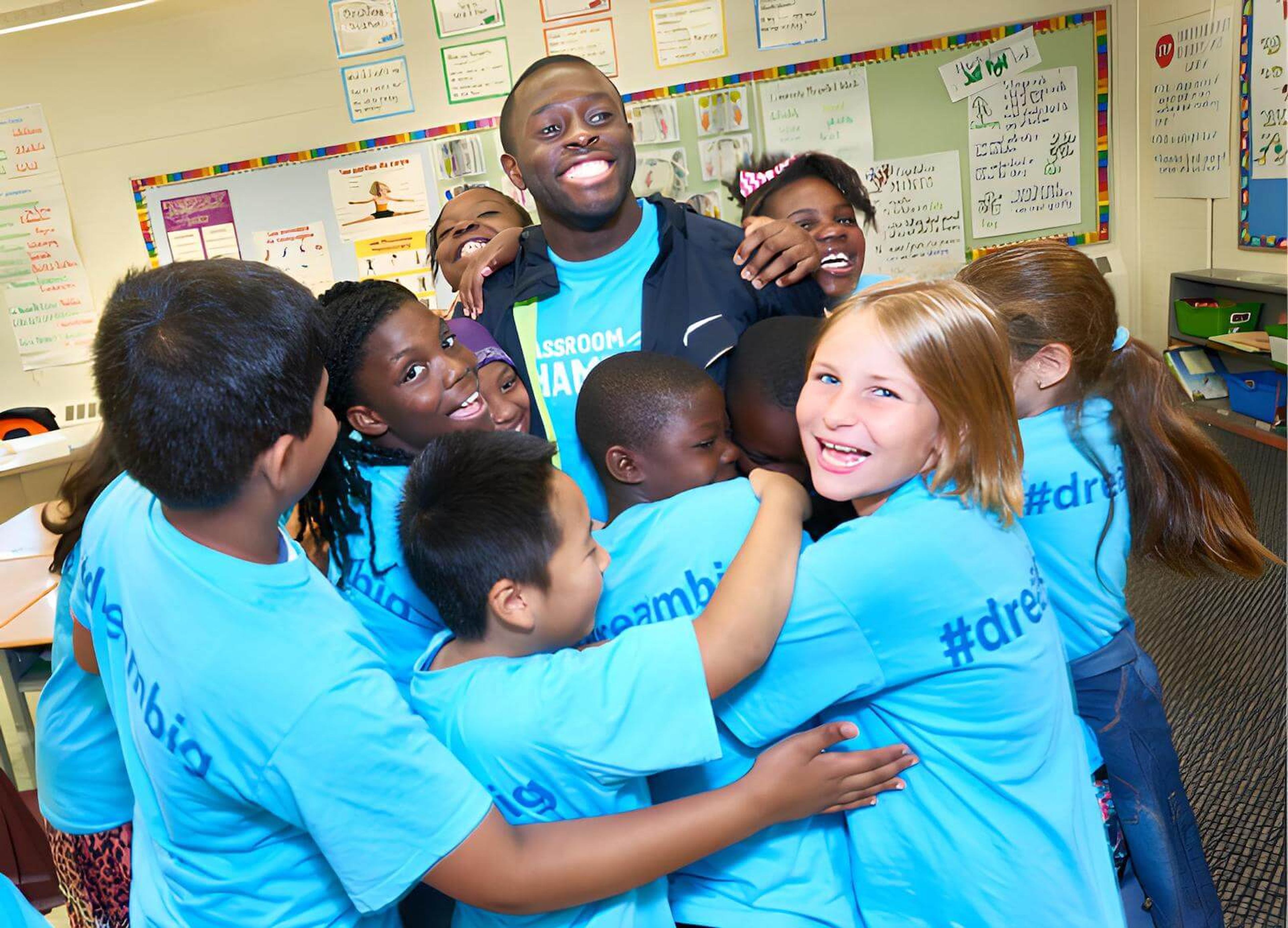 Athlete and group of Classroom Champions participants share a group hug