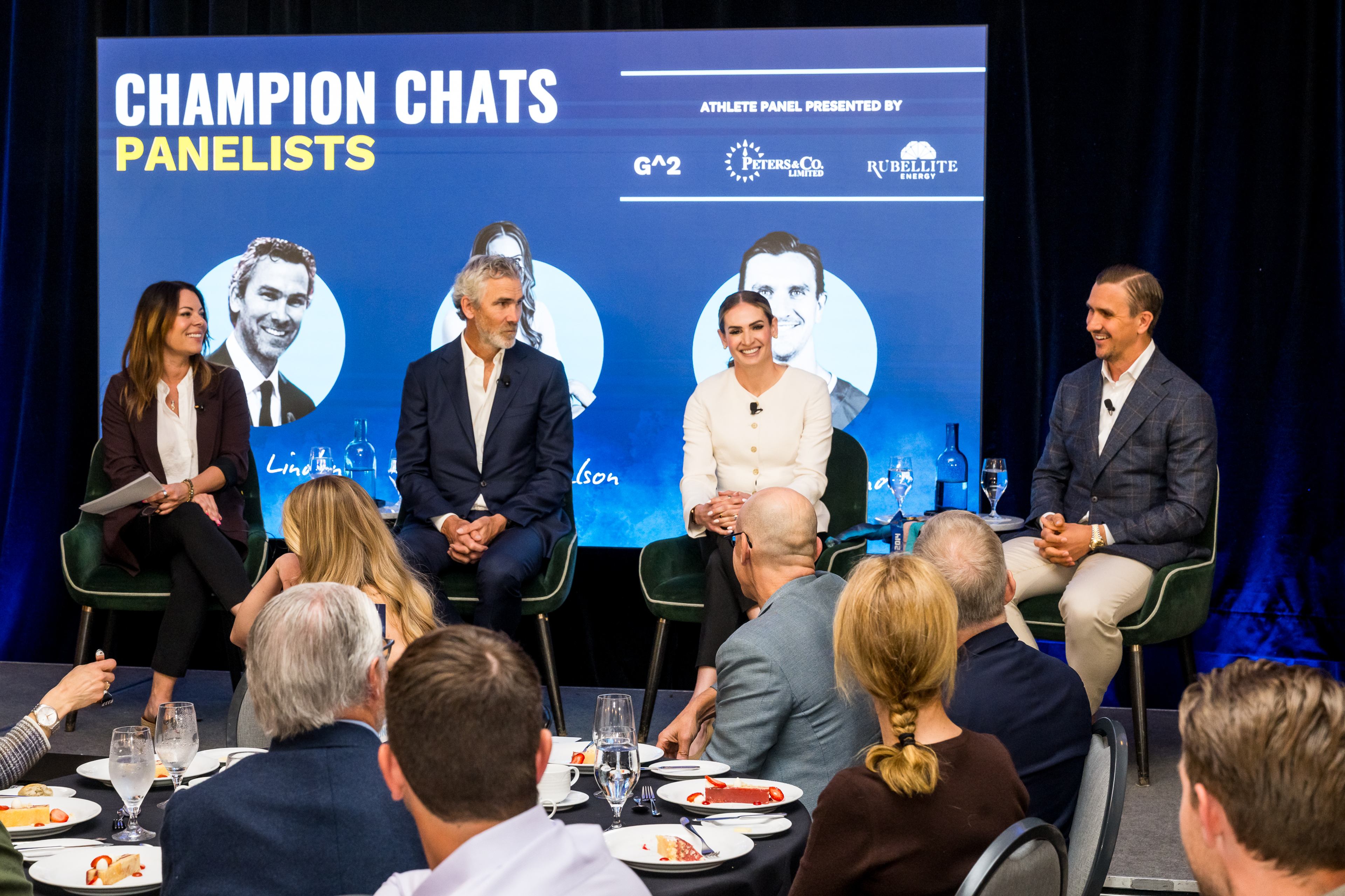 Athlete mentors speak on the Champion Chats panel before a seated audience at a Classroom Champions event.