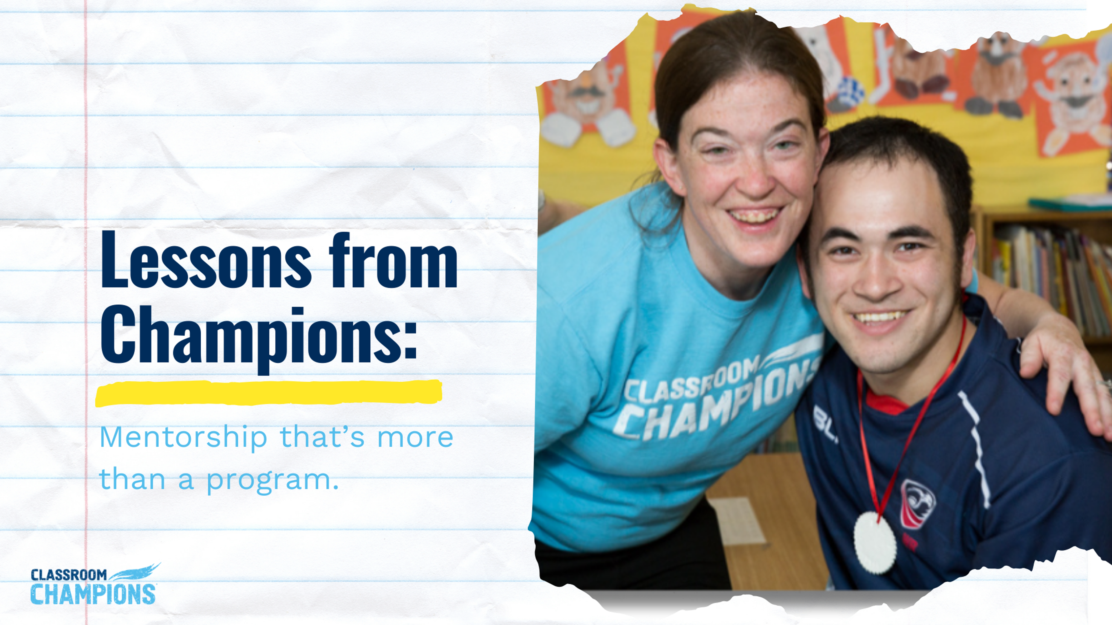 A Classroom Champions mentor and a mentee wearing a medal smile together in a classroom.