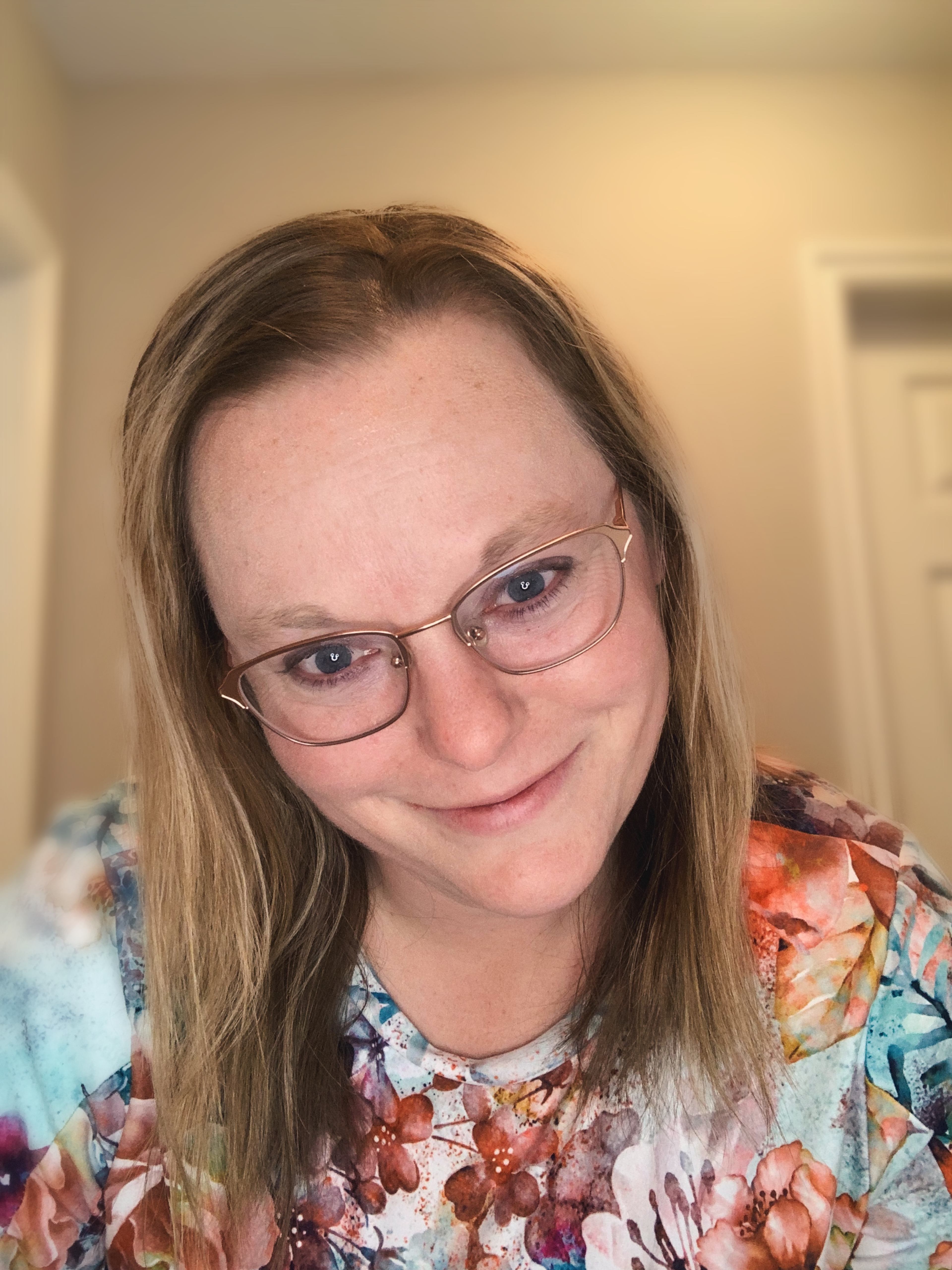 Headshot of Celine Slater smiling in a floral top.