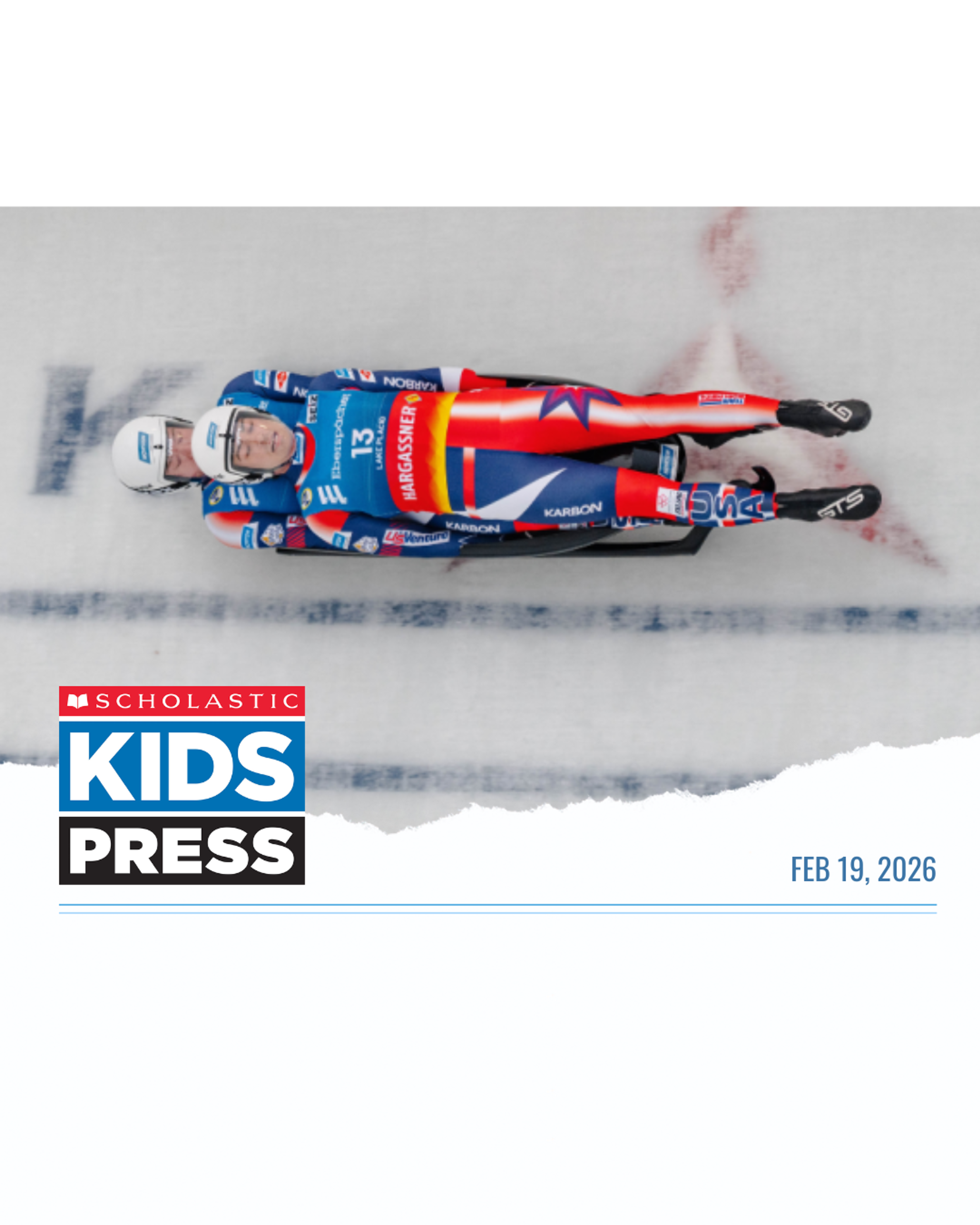 A luge athlete in USA gear races down an icy track, featured in a Scholastic Kids Press news story.