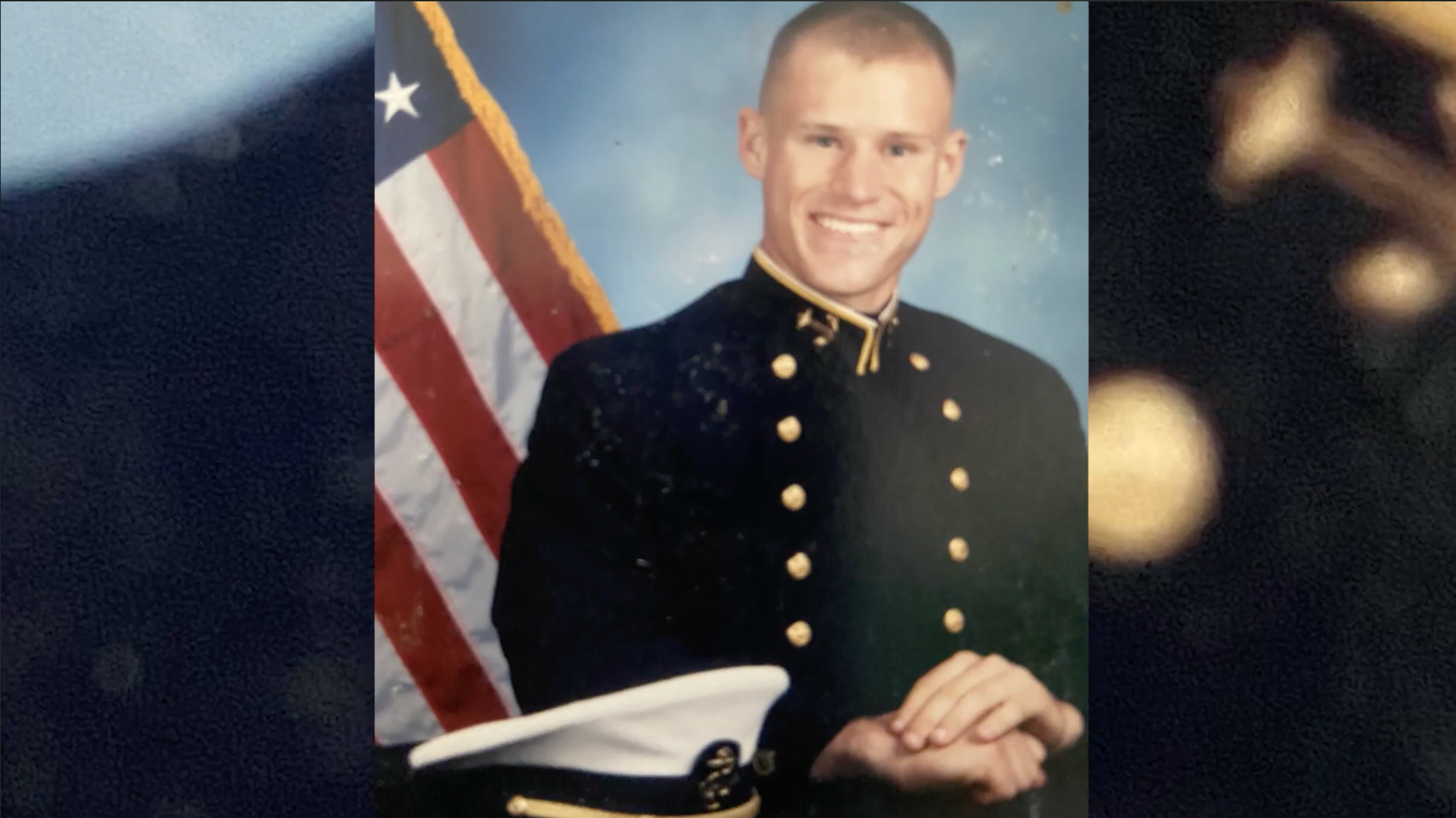 Dan Cnossen in his U.S. Naval Academy portrait, wearing dress uniform in front of an American flag.