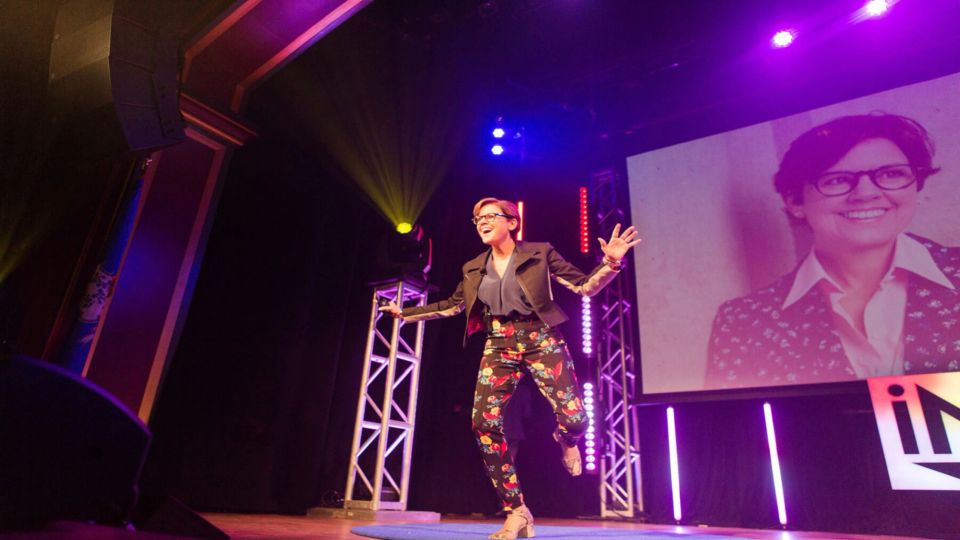 Ann Handley speaking on stage at a conference.