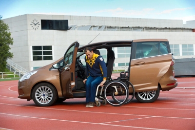 Brown minivan with Turnout rotating driver seat extended outward on running track