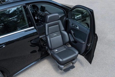 Black car with Turny Evo rotating and lowering passenger seat extended outward