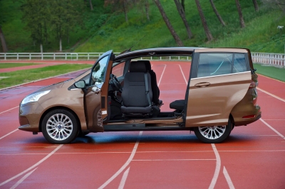 Brown compact minivan with passenger Turnout rotating seat extended outward