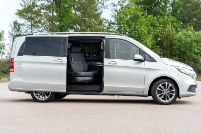 Silver minivan with Turny Evo rotating and lowering passenger seat extended outward
