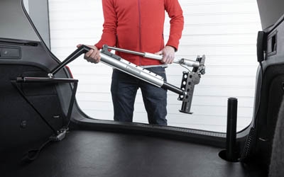 Person using Carolift 100 electric hoist to load mobility scooter
