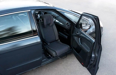 Dark-colored car with Turnout rotating seat extended outward from passenger side