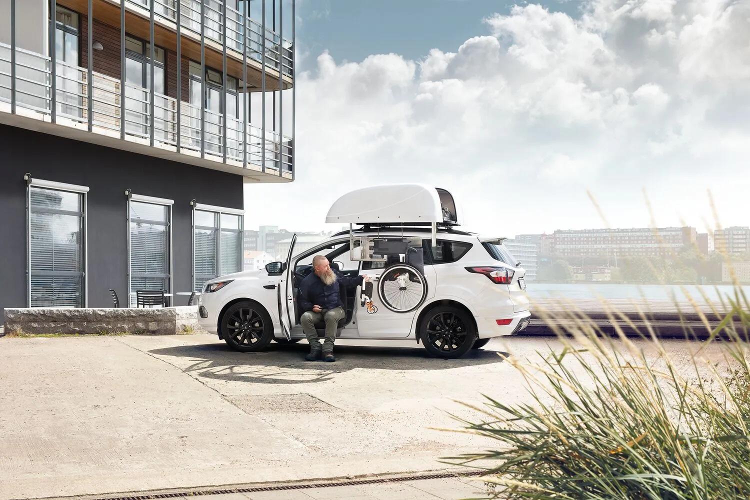 White SUV with Chair Topper roof-mounted storage system