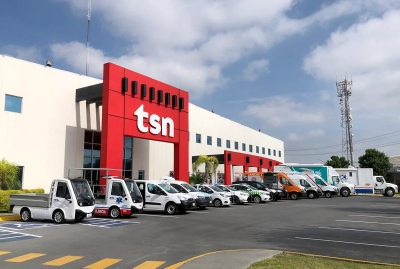 TSN headquarters with fleet of adapted vehicles including vans, ambulances, and utility trucks parked