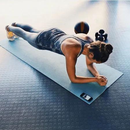 Woman stretching on yoga mat