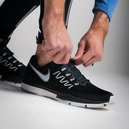 Man lacing up sneakers