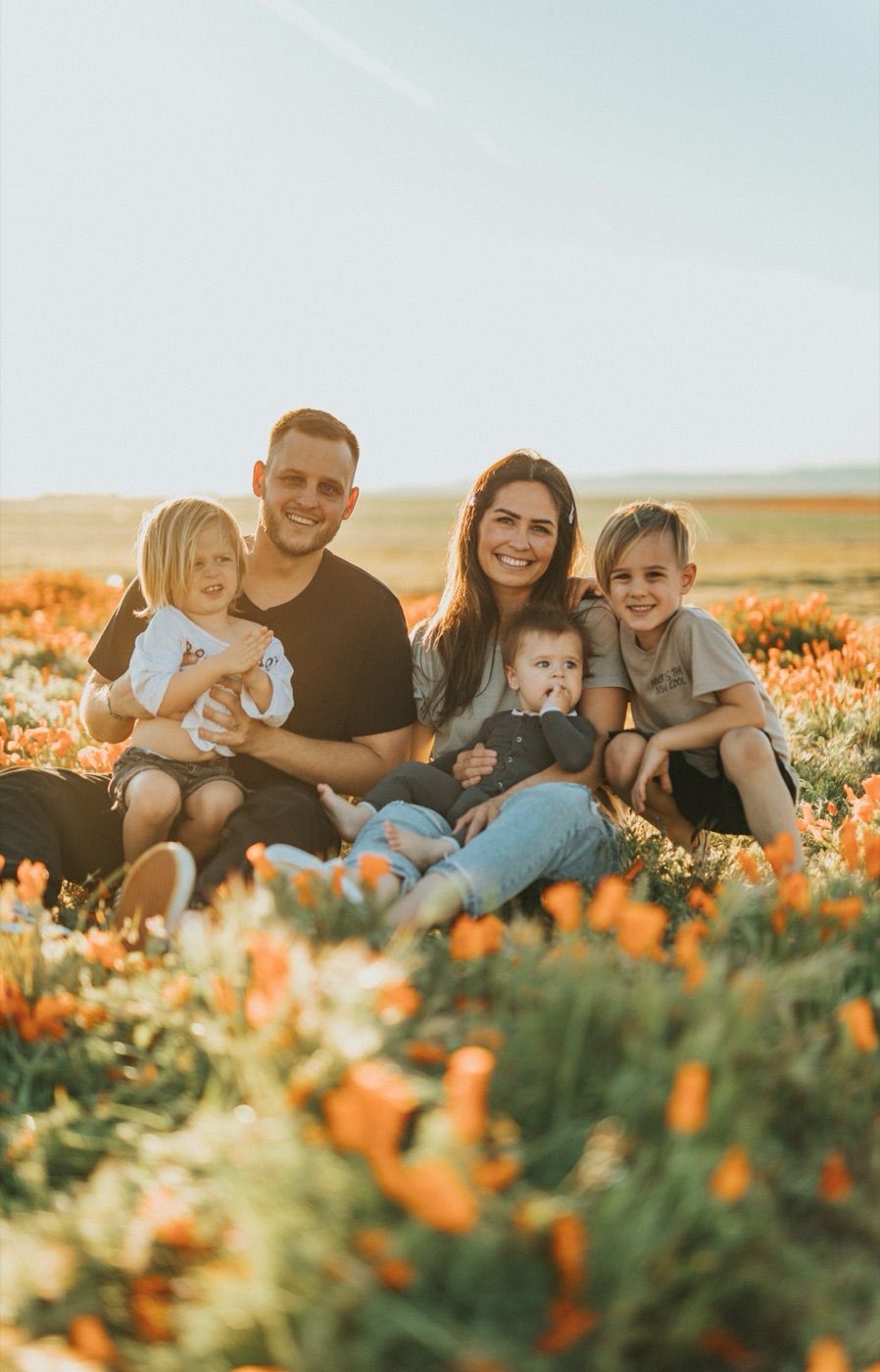 A family celebrating together in a field of flowers