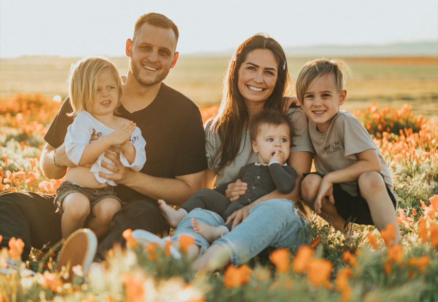 A family celebrating together in a field of flowers