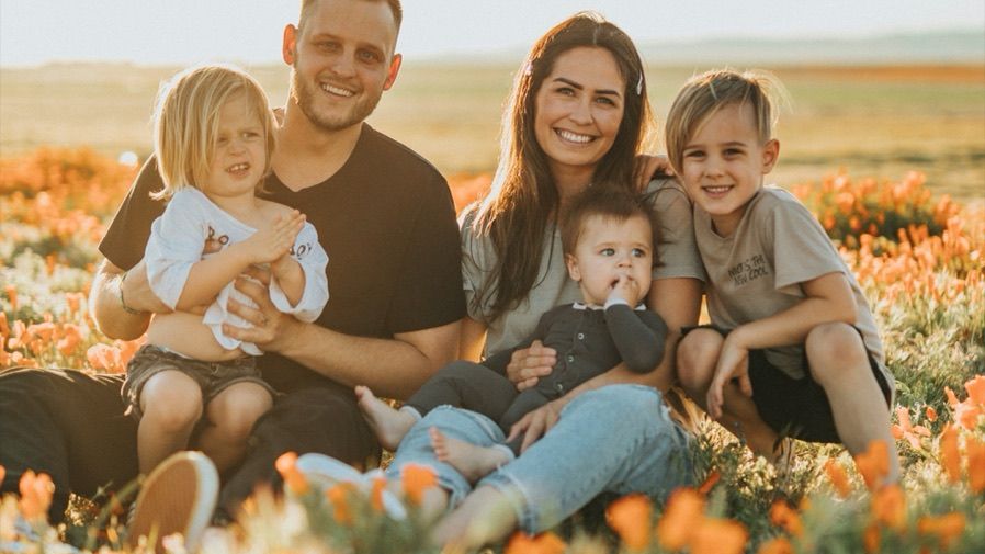 A family celebrating together in a field of flowers