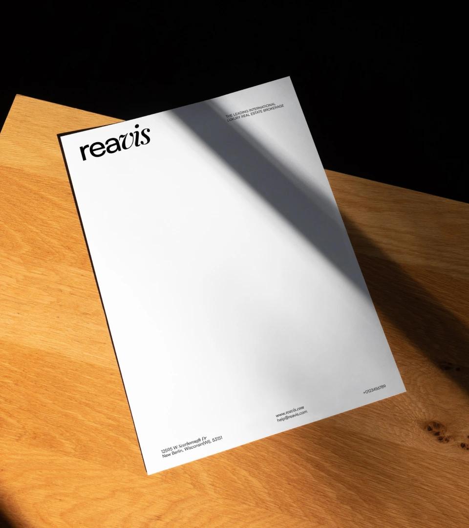 Reavis letterhead on a wooden desk