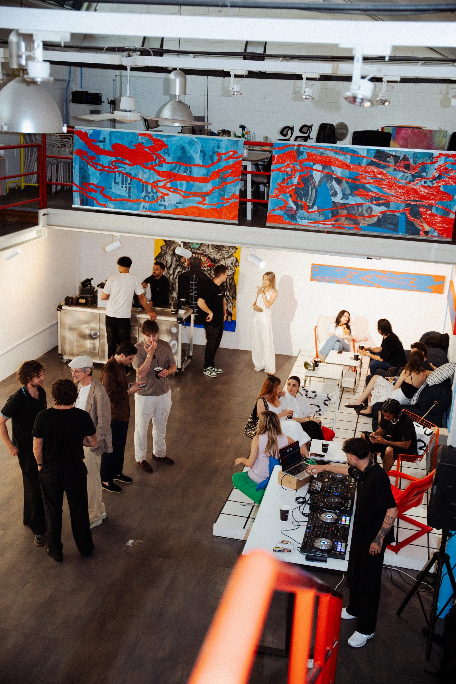 Guests exploring the Tales from Another World exhibition at Spazio ivy in Milan