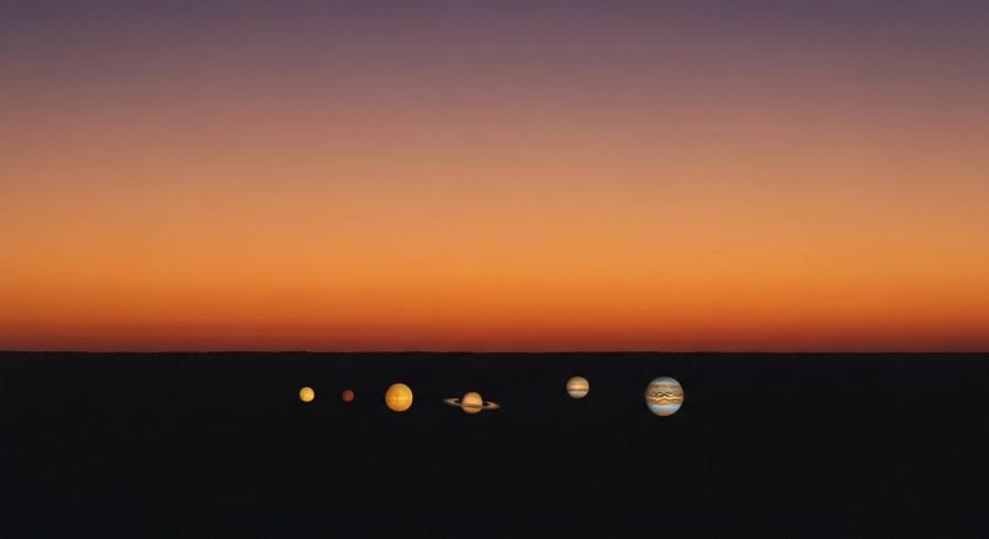 Sunset on the western horizon with planetary symbols descending - astrology descendant concept