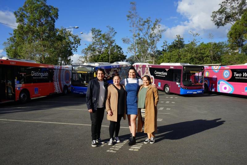 roy Casey, Casey Coolwell-Fisher, Rachel Sarra and Amanda Hayman in front of the Brisbane City Council First Nations buses