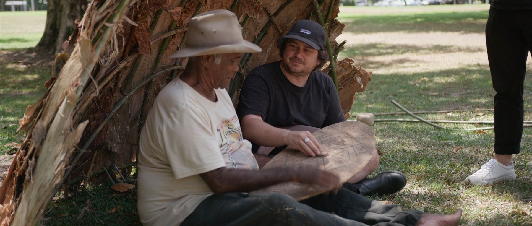 Bulmba, Uncle Peter ‘Bumi’ Hyde (Gimuy Elder) sitting beneath a bulmba, a traditional home, in Gimuy, Cairns