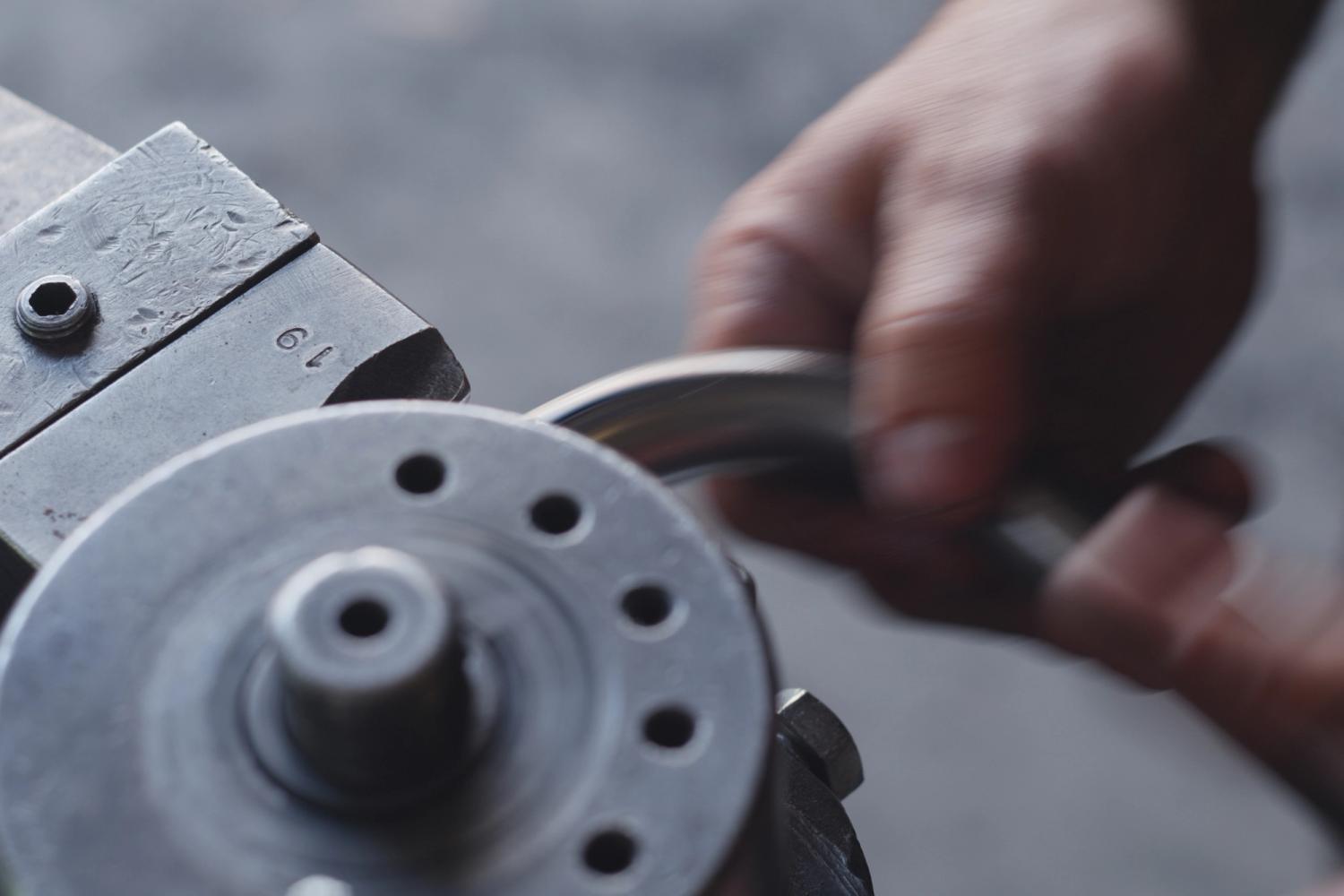 Close up of a hand using a machine to craft furniture