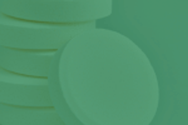 An image of a stack of white tablets with a green overlay.
