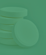An image of a stack of white tablets with a green overlay.