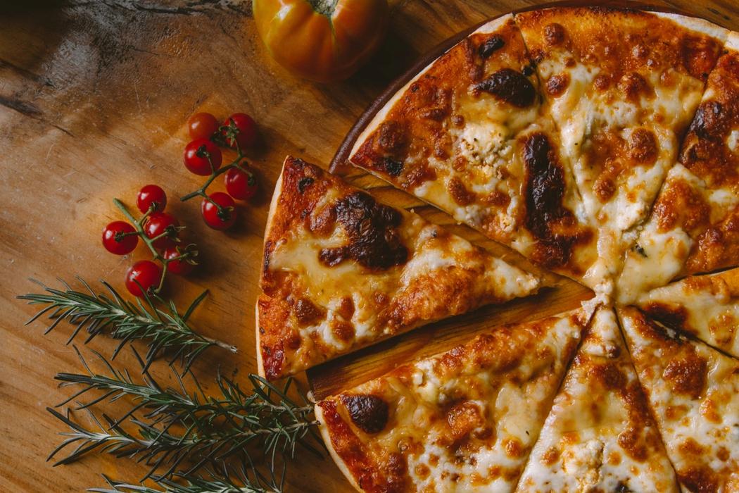 Cheese pizza on wooden platter