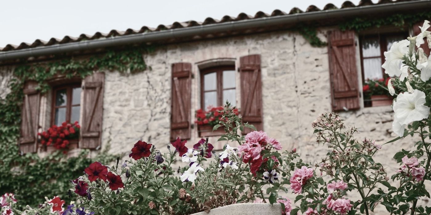 Traditional Provençal stone mas farmhouse surrounded by flowers in the Luberon
