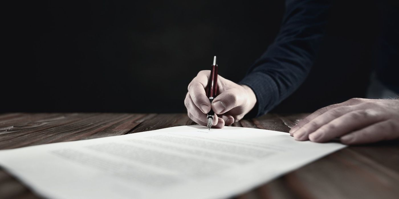 Legal documents on a notary desk with a pen signing the documentation
