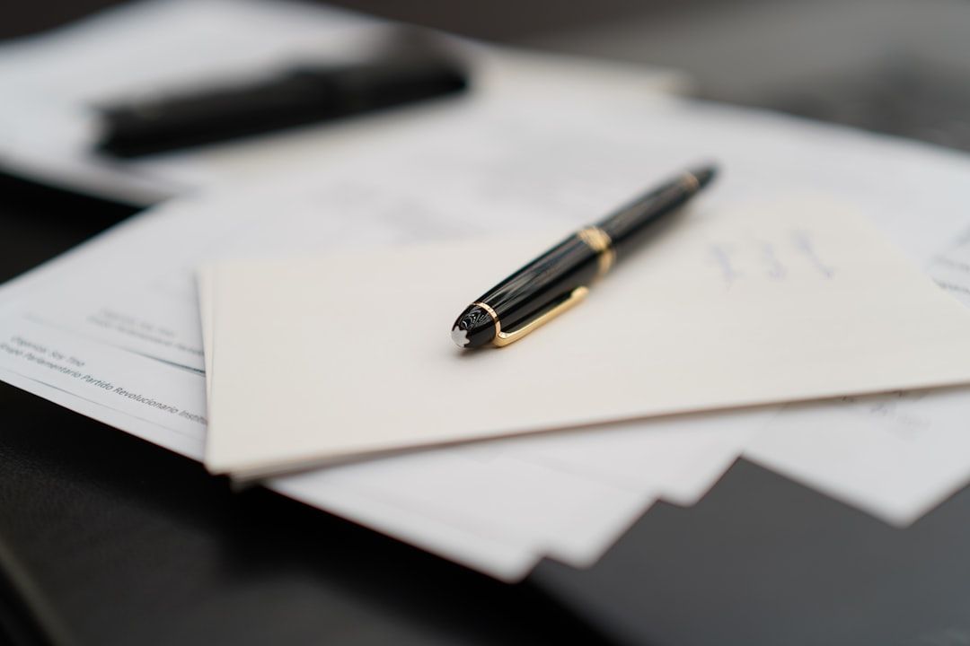 Signing legal documents at a notary desk with a pen