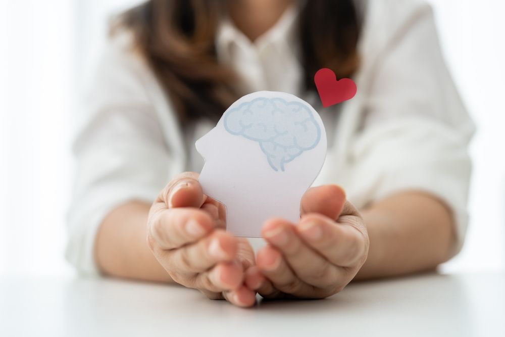 Medical student holding a brain cutout symbolizing a study routine that supports mental health and reduces stress in MS1 and MS2