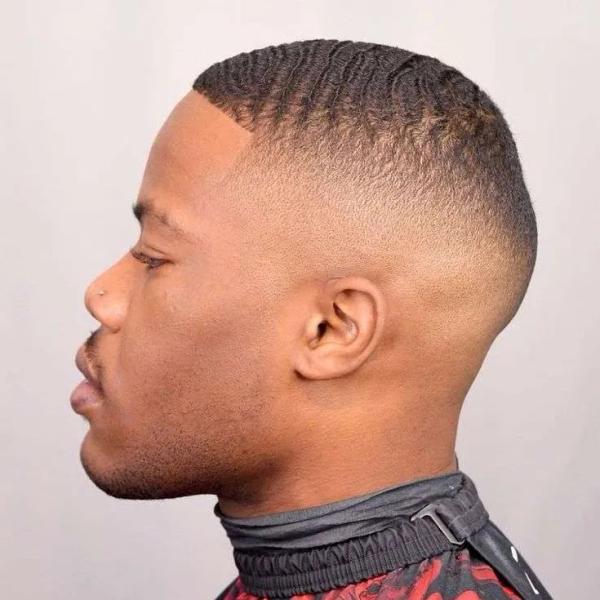 A skin fade taken down to the skin with a clean line up