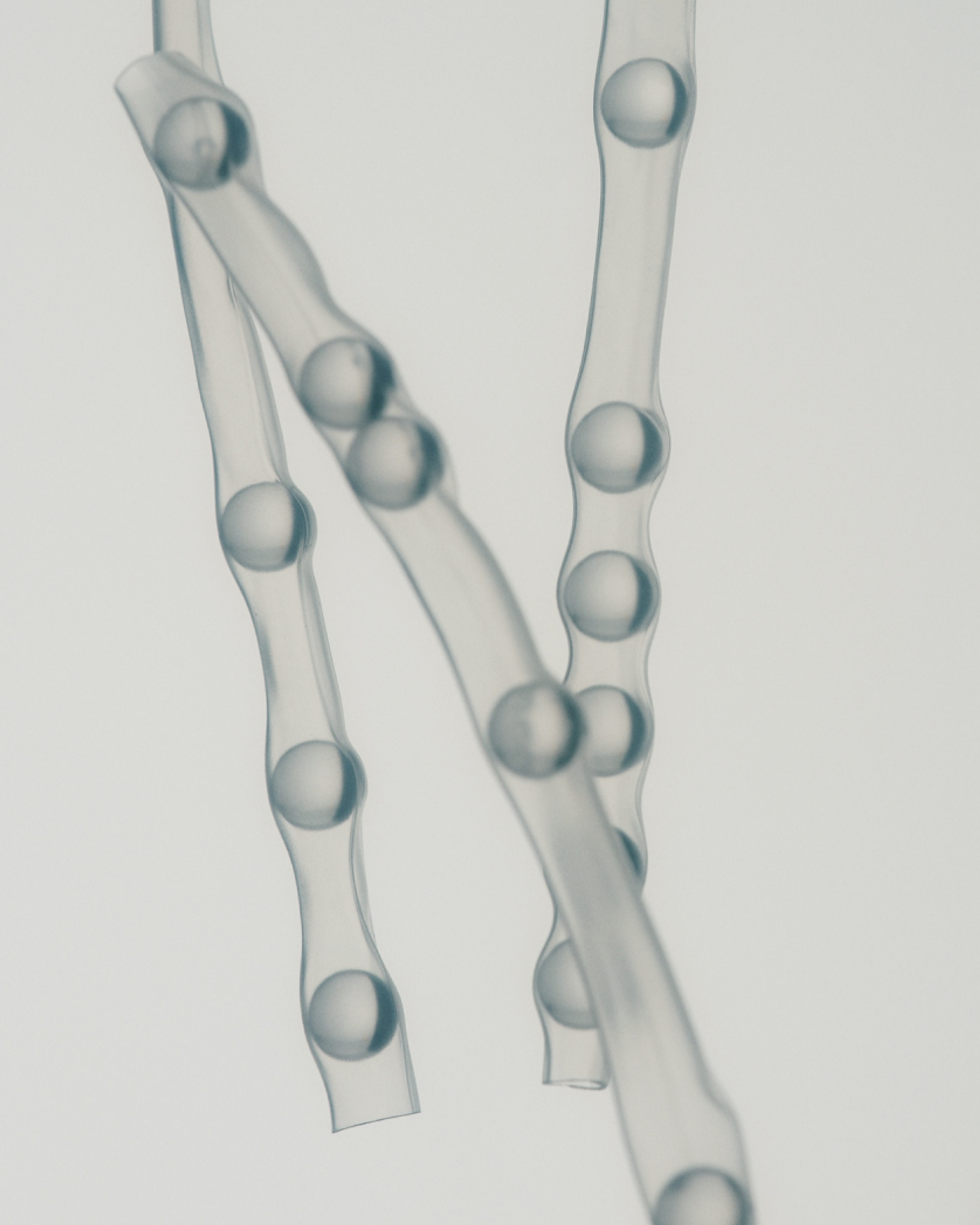 Water droplets suspended in translucent flowing strands